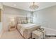 Cozy bedroom with soft carpet, a large bed, and elegant lighting fixture at 2013 Garden View Ln, Weddington, NC 28104