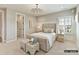 A well-lit bedroom with an elegant bed frame, comfortable bedding, and soft carpet at 2013 Garden View Ln, Weddington, NC 28104