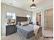 This bedroom features an adjacent bathroom, stylish design, and well-lit natural light at 2013 Garden View Ln, Weddington, NC 28104