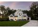 Stunning two-story white brick home featuring a beautifully landscaped front yard and a charming, covered front porch at 2013 Garden View Ln, Weddington, NC 28104