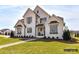 Charming two-story home with manicured lawn, brick facade and black trim on windows and eaves at 2013 Garden View Ln, Weddington, NC 28104