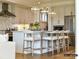 Bright kitchen featuring a large island with bar seating, stainless steel appliances, and ample cabinet space at 2013 Garden View Ln, Weddington, NC 28104