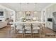 Spacious open kitchen with island seating, pendant lighting, white cabinets and stainless appliances at 2013 Garden View Ln, Weddington, NC 28104