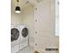 Well-lit laundry room featuring a side-by-side washer and dryer, and stylish patterned flooring at 2013 Garden View Ln, Weddington, NC 28104