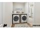 Laundry room with modern washer and dryer, folding counter, decor, and a doorway into a closet at 2013 Garden View Ln, Weddington, NC 28104