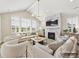 Bright living room with fireplace, beamed ceiling, plantation shutters and lots of natural light at 2013 Garden View Ln, Weddington, NC 28104