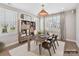 Office area featuring large windows with shutters, hardwood floors, wooden furniture, and a natural light fixture at 2013 Garden View Ln, Weddington, NC 28104