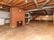 Unfinished basement showcasing a brick fireplace and staircase at 207 Oak Dr, Belmont, NC 28012