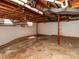 Unfinished basement with support beams and a small window for natural light at 207 Oak Dr, Belmont, NC 28012