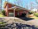 View of the exterior featuring a brick facade, carport, driveway, and front yard at 207 Oak Dr, Belmont, NC 28012