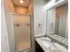 Bathroom featuring tiled shower, vanity with granite countertop, and decorative mirror at 218 Cottonwood Park Dr, Charlotte, NC 28214
