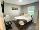 Bedroom with queen-size bed, wood floors, and bright natural light from the window at 218 Cottonwood Park Dr, Charlotte, NC 28214