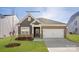 Charming single Gathering home featuring a two-car garage, stone accents, and manicured lawn at 2315 Riggs Rd, Sherrills Ford, NC 28673