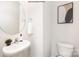 Powder room featuring a modern sink and round mirror at 2319 Riggs Rd, Sherrills Ford, NC 28673