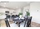 Open-concept dining room next to kitchen with modern table, chairs and décor at 2319 Riggs Rd, Sherrills Ford, NC 28673