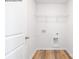 A well-lit laundry room with washer/dryer hookups and a wire shelf for organization at 2319 Riggs Rd, Sherrills Ford, NC 28673