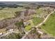 Wide aerial view of the property with plentiful greenery, woods, pond and nearby structures at 260 Charlie Stacks Rd, Lancaster, SC 29720