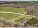 Expansive aerial view of the property, including the lawn, nearby pond, and surrounding wooded area at 260 Charlie Stacks Rd, Lancaster, SC 29720
