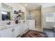 Beautiful bathroom with double marble sinks, white cabinetry, an accent rug, and a glass shower at 260 Charlie Stacks Rd, Lancaster, SC 29720