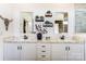 A bathroom with double sinks with marble countertops, white cabinetry, and a decorative wall at 260 Charlie Stacks Rd, Lancaster, SC 29720