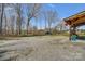 A landscape showing the gravel area and an outdoor patio with hanging plants at 260 Charlie Stacks Rd, Lancaster, SC 29720