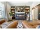 Living room fireplace with a sleek design, shelving, and statement chairs at 260 Charlie Stacks Rd, Lancaster, SC 29720