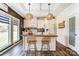 Charming kitchen with an island, butcher block countertop, white cabinets, and modern fixtures at 260 Charlie Stacks Rd, Lancaster, SC 29720