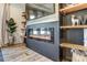 Modern living room with a cozy fireplace, built-in shelves, a flat-screen television, and light wood flooring at 260 Charlie Stacks Rd, Lancaster, SC 29720