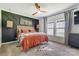 Bright main bedroom with a wood-paneled accent wall, ceiling fan, gray carpet, and natural light at 260 Charlie Stacks Rd, Lancaster, SC 29720