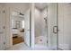 En-suite bathroom featuring a glass enclosed walk-in shower with neutral tile at 2622 Sheffield Crescent Ct, Charlotte, NC 28226