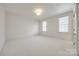 Spacious bedroom featuring plush carpeting and bright natural lighting from large windows at 2622 Sheffield Crescent Ct, Charlotte, NC 28226