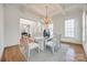 Bright dining area with elegant chandelier, coffered ceilings, and easy flow to other rooms at 2622 Sheffield Crescent Ct, Charlotte, NC 28226