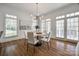 Bright dining room featuring hardwood floors, a modern chandelier, and large windows offering plenty of natural light at 2622 Sheffield Crescent Ct, Charlotte, NC 28226