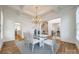 Elegant dining area with coffered ceiling, modern chandelier, and easy access to the kitchen at 2622 Sheffield Crescent Ct, Charlotte, NC 28226