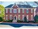 Charming brick home featuring multi-pane windows, elegant arched entryway, and manicured landscaping at 2622 Sheffield Crescent Ct, Charlotte, NC 28226
