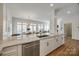 Bright kitchen features white cabinets, granite counters, and stainless steel appliances with open floor plan at 2622 Sheffield Crescent Ct, Charlotte, NC 28226