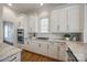 The kitchen has marble countertops, white cabinetry, and stainless steel appliances, all set in a brightly lit space at 2622 Sheffield Crescent Ct, Charlotte, NC 28226
