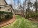 Well-maintained backyard with lush greenery and a manicured lawn at 2905 Polo View Ln, Matthews, NC 28105