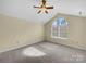 Comfortable bedroom with ceiling fan, neutral carpet, and natural light streaming in from the arched window at 2905 Polo View Ln, Matthews, NC 28105