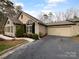 Charming home with stone accents, a well-maintained yard, and an attached garage at 2905 Polo View Ln, Matthews, NC 28105