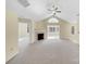 Spacious living room with fireplace and neutral carpet leading to the sunroom at 2905 Polo View Ln, Matthews, NC 28105