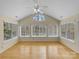 Bright sunroom with hardwood floors, ceiling fan, and large windows providing great natural light at 2905 Polo View Ln, Matthews, NC 28105