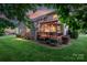 Backyard view showcasing a wooden deck with a pergola and a stone fireplace at 3017 Chisholm Ct, Waxhaw, NC 28173