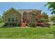 A home's brick exterior leads to a spacious wood deck featuring a stone fireplace and pergola at 3017 Chisholm Ct, Waxhaw, NC 28173