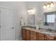 Bathroom with a double vanity, granite countertops and modern lighting fixtures at 3017 Chisholm Ct, Waxhaw, NC 28173