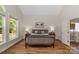 Spacious bedroom featuring a window with natural light and hardwood floors at 3017 Chisholm Ct, Waxhaw, NC 28173