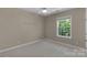 Cozy bedroom with neutral carpet, ceiling fan and bright window, offering a peaceful retreat at 3017 Chisholm Ct, Waxhaw, NC 28173