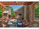 Outdoor deck with a stone fireplace, television and outdoor seating with dining area at 3017 Chisholm Ct, Waxhaw, NC 28173