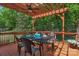 Spacious wooden deck with a pergola, dining table and chairs for outdoor dining at 3017 Chisholm Ct, Waxhaw, NC 28173