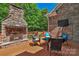 Deck area with a stone fireplace and comfortable seating, ideal for relaxation at 3017 Chisholm Ct, Waxhaw, NC 28173